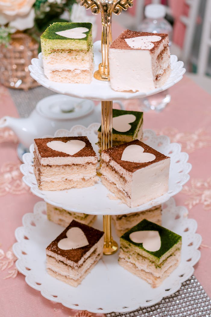 A stylish display of assorted layer cakes on a tiered stand, perfect for celebrations.